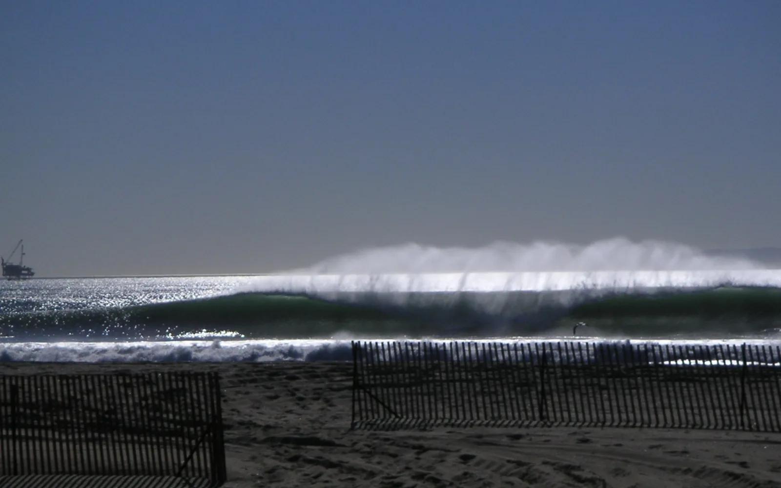 Big waves breaking at Bolsa Chica State Beach in late fall with 15-foot surf